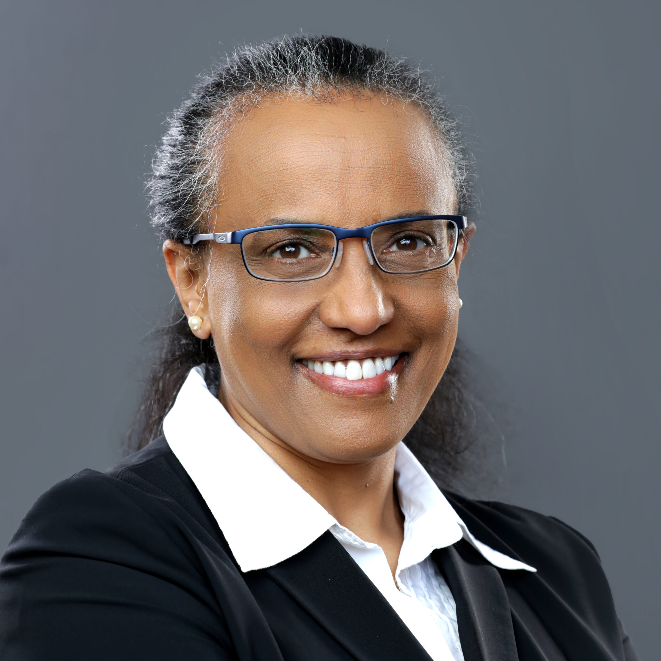 Professional Headshot on grey background for a woman